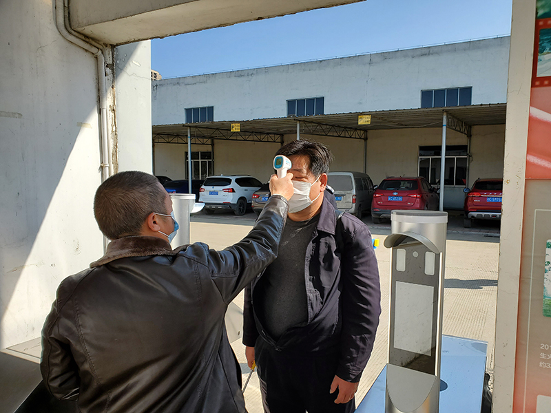 社網(wǎng)站4門(mén)衛給入廠(chǎng)員工進(jìn)行體溫監測（黃志攝）.jpg